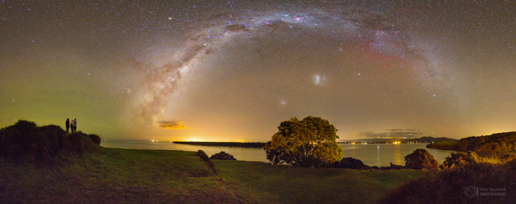 Three girls and three galaxies above the bay